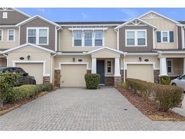 Attractive two-story townhome with a paved driveway and landscaping at 18909 Ulmus St, Lutz, FL 33558