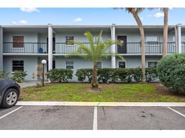 Two-story condo building with palm trees and parking at 2835 Somerset Park Dr # 103, Tampa, FL 33613