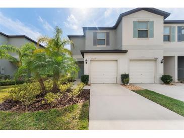 Two-story house with attached garage and landscaping at 7227 Sweet Alyssum Ct, Tampa, FL 33619