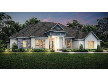 Stunning one-story home with stone accents and a landscaped lawn at 13510 Haflinger Way, Hudson, FL 34667