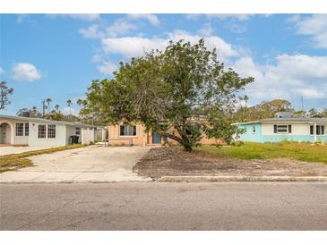 Ranch-style house with a large front yard and mature tree at 4000 Huntington Ne St, St Petersburg, FL 33703