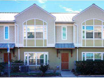 Front view of charming townhome with attractive facade and landscaping at 1275 Drew St, Clearwater, FL 33755