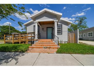 Charming house with a teal front door and welcoming porch at 2515 N Howard Ave, Tampa, FL 33607