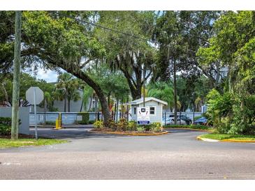 Gated community entrance with lush landscaping and security booth at 7124 Waterside Dr # 7124, Tampa, FL 33617