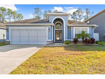 Single-story home with two-car garage and landscaped lawn at 12922 Saulston Pl, Hudson, FL 34669