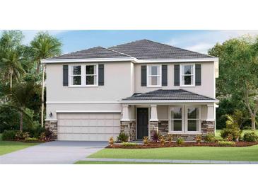 Two-story house with gray shutters, stone accents, and a two-car garage at 17916 Tavernside Trl, Lakewood Ranch, FL 34211