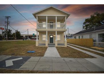 Two-story house with a front porch and driveway at 2204 E 12Th Ave, Tampa, FL 33605