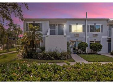 Front view of a two-story condo building with landscaping at 4128 Dolphin Dr, Tampa, FL 33617