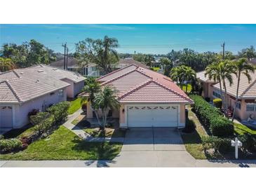 Attractive single-story home with tile roof, two-car garage, and landscaped yard at 4415 Muirfield, Bradenton, FL 34210