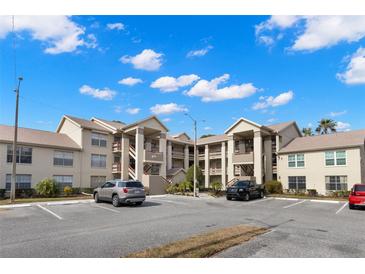 Two-story condo building with ample parking and landscaping at 4529 Whitton Way # 211, New Port Richey, FL 34653