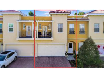 Front view of charming two-story townhome with a double-car garage and balcony at 614 105Th N Ln, St Petersburg, FL 33716