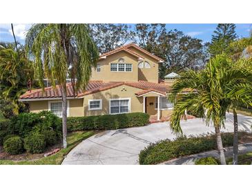 Attractive two-story home with tile roof and landscaped yard at 660 Geneva Pl, Tampa, FL 33606