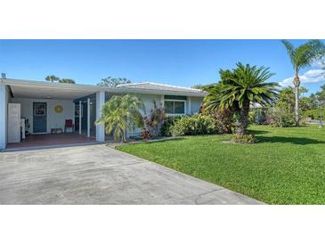 Charming single story home with a well manicured lawn and tropical landscaping at 1366 Stafford Ln # 1420, Sarasota, FL 34232