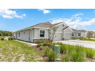 Single-story home with attached garage and landscaped yard at 18129 Cropside Trl, Lakewood Ranch, FL 34211