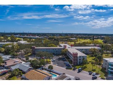 Aerial view of a condo building with a pool and surrounding landscape at 2363 Israeli Dr # 61, Clearwater, FL 33763