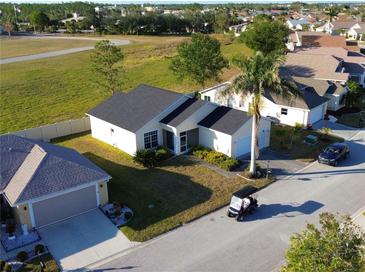 Aerial view of a single-Gathering home with a golf course nearby at 24165 Buckingham Way, Punta Gorda, FL 33980