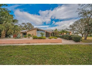 Brick ranch home with landscaped yard and walkway at 3201 Belmore Rd, Tampa, FL 33618