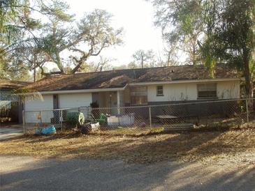 Ranch-style home with attached garage and fenced yard at 3401 Riderwood Dr, Dade City, FL 33523