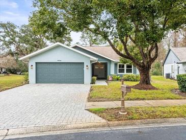 Updated single-story home with gray garage door and paver driveway at 7436 Baltusrol Dr, New Port Richey, FL 34654