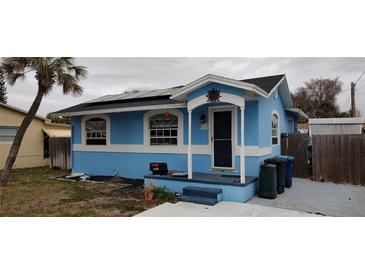 Charming blue house with solar panels and a small front yard at 7623 Gulf Blvd, St Pete Beach, FL 33706