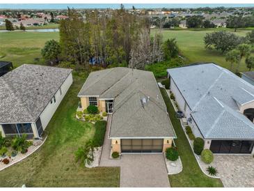 Aerial view of single-story house with golf course views and a spacious yard at 1123 Emerald Dunes Dr, Sun City Center, FL 33573