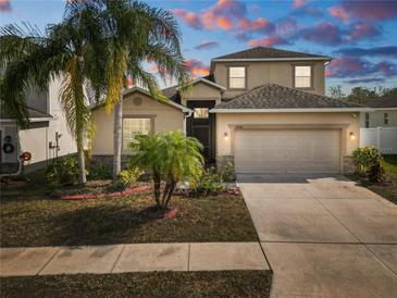 Two-story house with attached garage and landscaping at 18398 Aylesbury Ln, Land O Lakes, FL 34638