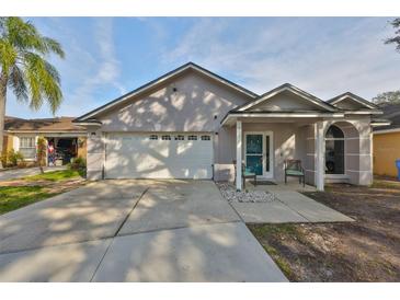 One-story house with a two-car garage and landscaped yard at 305 Crayford Pl, Valrico, FL 33594