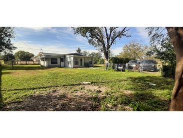 Spacious backyard with large grassy area and home in view at 35204 Ponderosa Rd, Zephyrhills, FL 33541