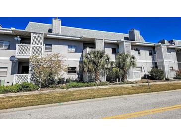 Two-story building exterior with balconies and landscaping at 4405 W Fair Oaks Ave # 10, Tampa, FL 33611