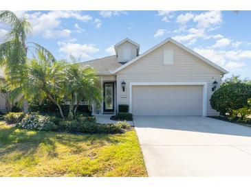 Single-story home with landscaped front yard, attached garage, and neutral exterior at 5004 Brickell Park Cv, Bradenton, FL 34211