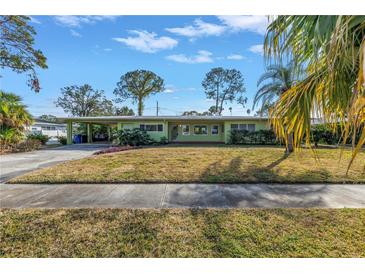 Green Ranch style home with carport and mature landscaping at 6170 7Th N Ave, St Petersburg, FL 33710