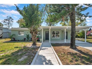 Newly renovated home with covered porch and landscaped yard at 6629 Travis Blvd, Tampa, FL 33610