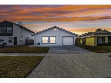 Updated single-story home with attached garage and well-manicured lawn at 10323 Del Mar Cir, Tampa, FL 33624