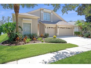 Two-story home boasts a 3-car garage and manicured landscaping, enhancing its curb appeal at 15555 Martinmeadow Dr, Lithia, FL 33547