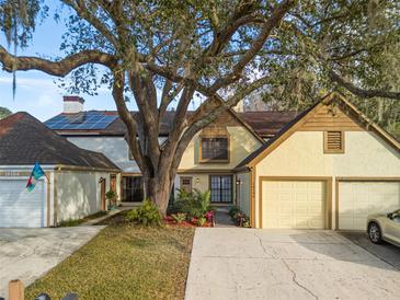 Two-story townhome with attached garage and mature landscaping at 16106 Dawnview Dr, Tampa, FL 33624