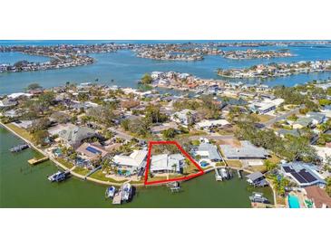 Aerial view of waterfront property with large lot and boat dock at 1897 Clearwater Harbor Dr, Largo, FL 33770