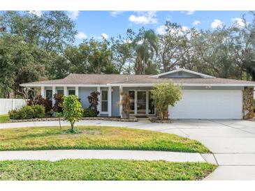 Single-story house with attached garage and manicured lawn at 1903 Oro Ct, Clearwater, FL 33764