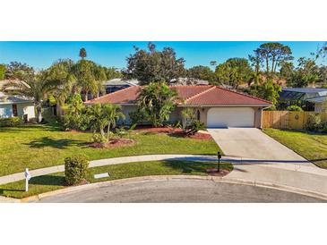 Single-story home with tile roof, landscaped yard, and driveway at 2851 Hardee Dr, Sarasota, FL 34231