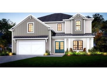 Charming two-story home with modern farmhouse design, manicured lawn, and inviting curb appeal at 5703 S Macdill Ave, Tampa, FL 33611