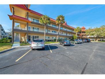 Two-story condo building with ample parking and tropical landscaping at 2402 Ecuadorian Way # 28, Clearwater, FL 33763