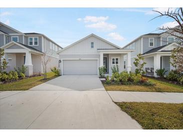 Two-story Craftsman home with gray siding, white accents, and a two-car garage at 5936 Golden Nettle Dr, Apollo Beach, FL 33572