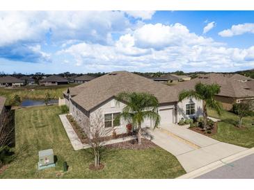 Beautiful aerial view of the home showcasing its well-maintained landscaping and curb appeal at 13387 Crest Lake Dr, Hudson, FL 34669
