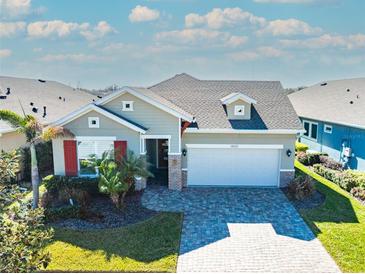 Attractive single-story home with a two-car garage and landscaped yard at 14015 Kingfisher Glen Dr, Lithia, FL 33547