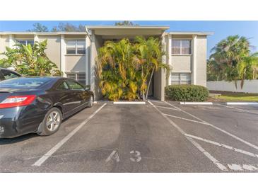 Exterior view of condo building with parking and landscaping at 304 S Habana Ave # A3, Tampa, FL 33609