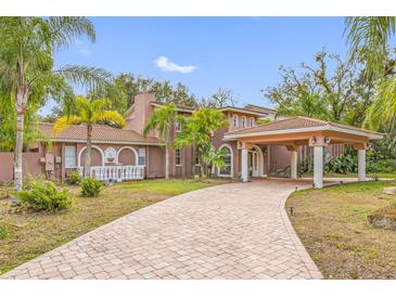 Grand two-story home with tile roof and covered entry at 3704 Berger Rd, Lutz, FL 33548