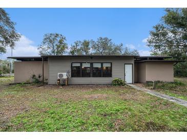 Ranch style home with brown siding and large windows at 5023 Bobwhite Ct # 2, Dade City, FL 33523