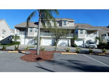 Three-story townhome with attached garage and landscaping at 8222 Brent St, Port Richey, FL 34668