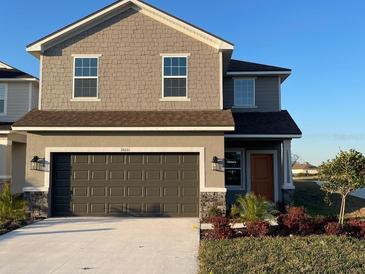 Two-story house with dark brown garage door and landscaping at 36111 Welsh Glade Rd, Dade City, FL 33525