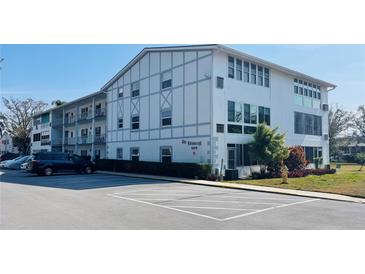 Exterior view of a two-story building with parking at 400 Glennes Ln # 108, Dunedin, FL 34698