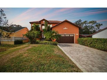 Attractive two-story house with a brick driveway and lush landscaping at 4414 Waltham Dr, Tampa, FL 33634